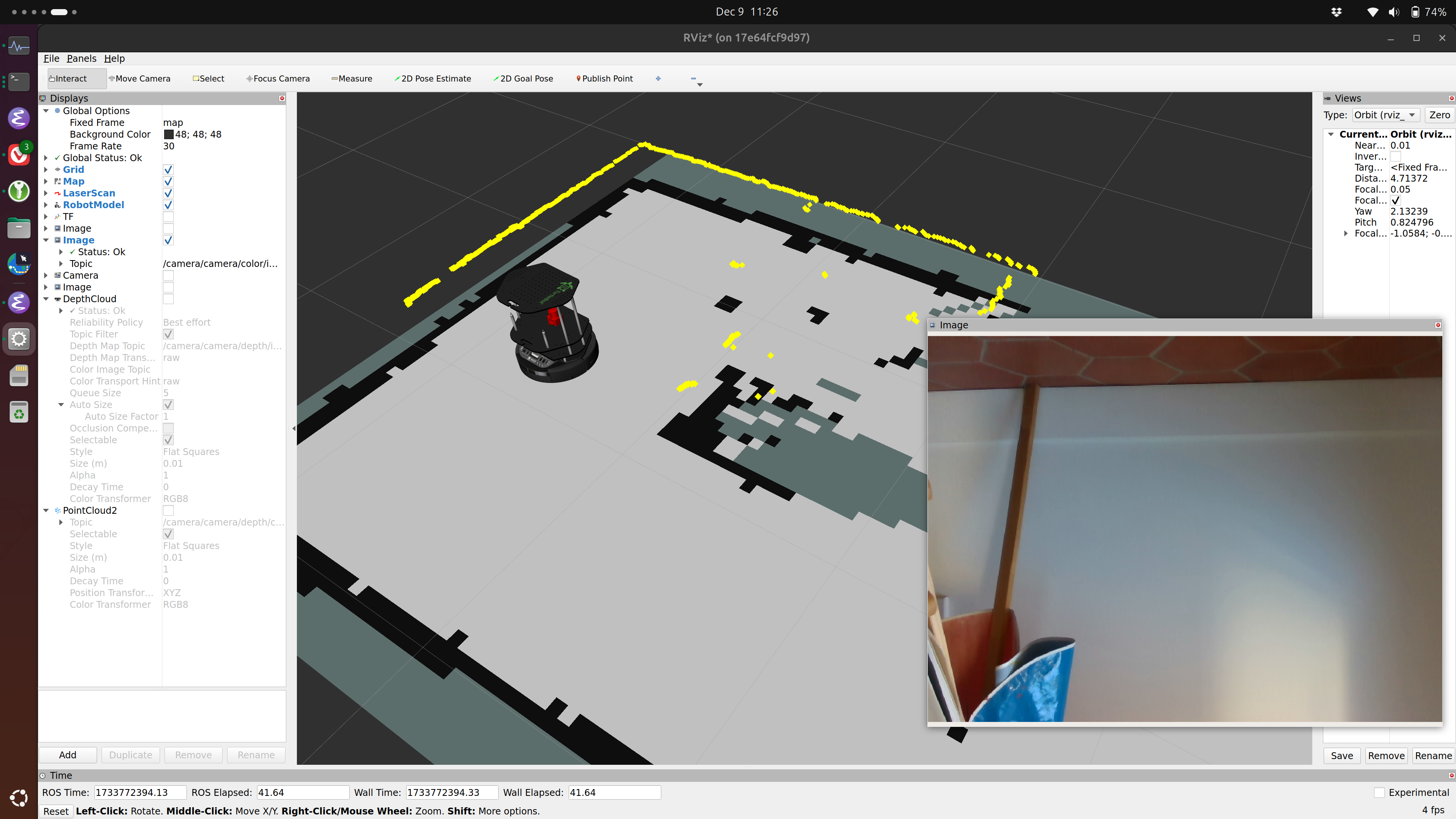 Screenshot of RViz showing Turtlebot2 exploring a room with laser scan points in yellow.